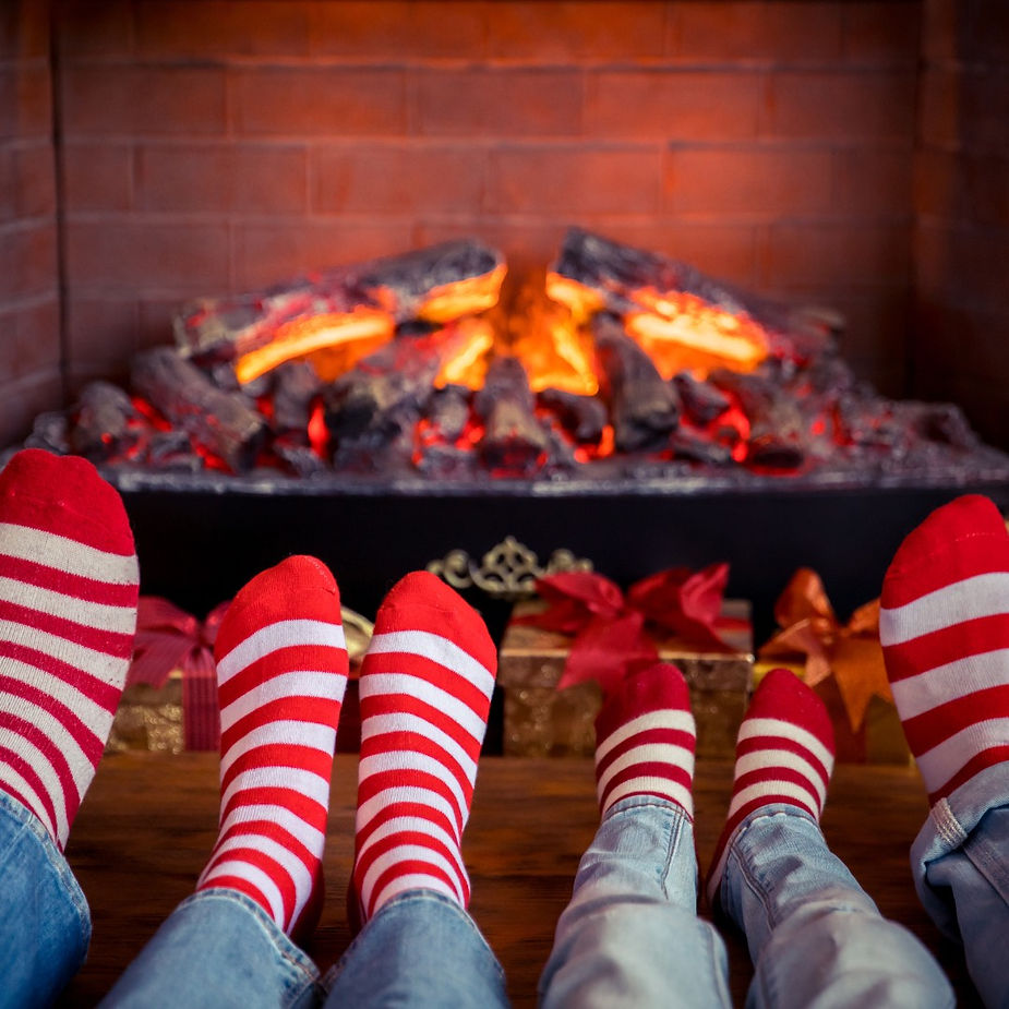 A family of four in festive mood- each wearing red and white stripped socks