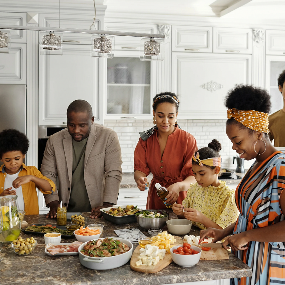 A family of six sharing holiday meal preparation task