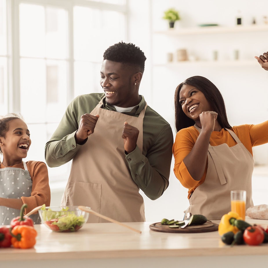 A nuclear family having a fun time while cooking